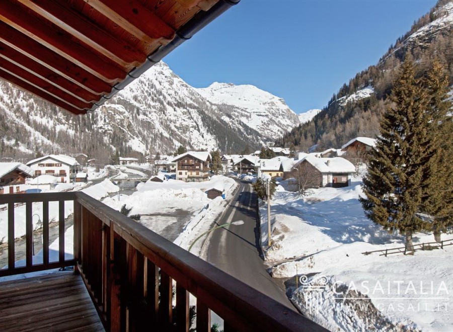 This stunning chalet boasts breathtaking views of the snow-capped mountains and charming village.
