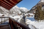This stunning chalet boasts breathtaking views of the snow-capped mountains and charming village.