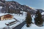 This stunning chalet boasts breathtaking mountain views and is nestled in a picturesque winter wonderland.
