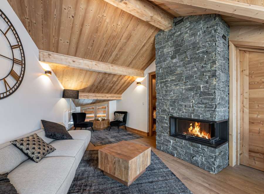 Cozy mountain chalet with a stunning stone fireplace as the centerpiece.