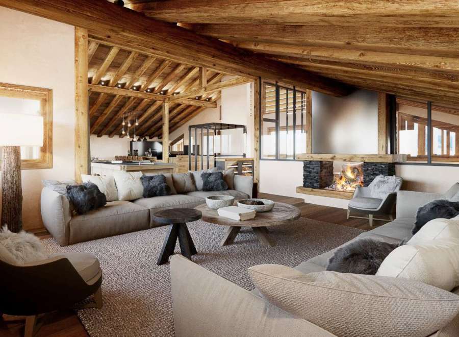 This stunning chalet boasts a spacious open-plan living area with exposed wooden beams and a cozy fireplace, perfect for relaxing after a day on the slopes.