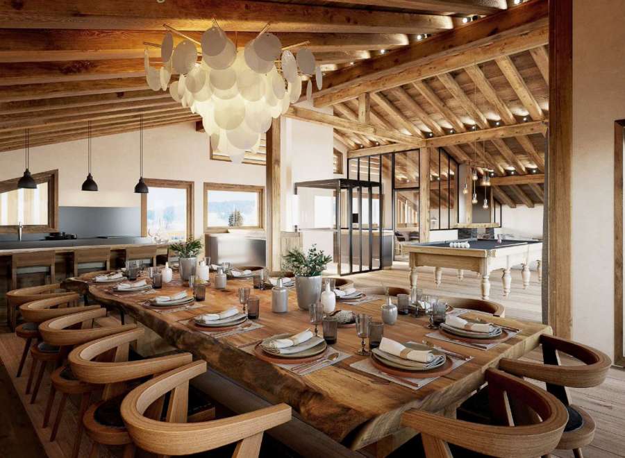 This stunning chalet boasts a spacious open-plan living area with a large wooden dining table perfect for gatherings.