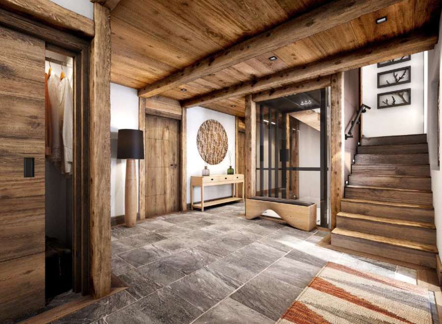 This stunning chalet boasts a spacious entryway with a blend of rustic wood and modern elegance.