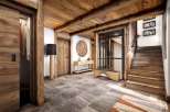 This stunning chalet boasts a spacious entryway with a blend of rustic wood and modern elegance.