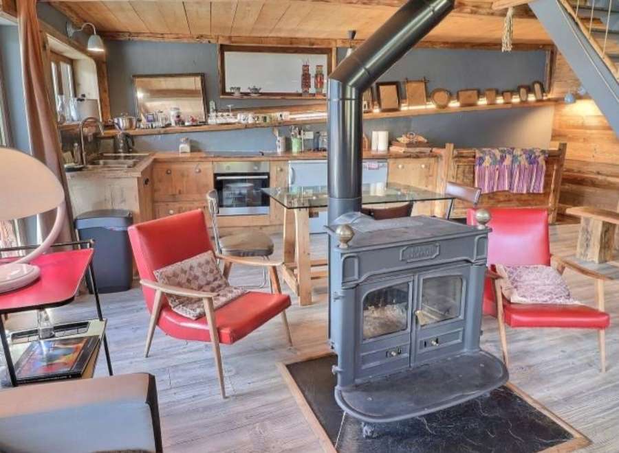 Cozy chalet with a wood-burning stove as the centerpiece, perfect for a relaxing winter getaway.