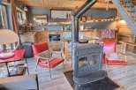 Cozy chalet with a wood-burning stove as the centerpiece, perfect for a relaxing winter getaway.