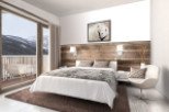 This stunning bedroom boasts a cozy and modern design, featuring a plush bed with a faux fur throw, a rustic wood accent wall, and large windows offering breathtaking mountain views.