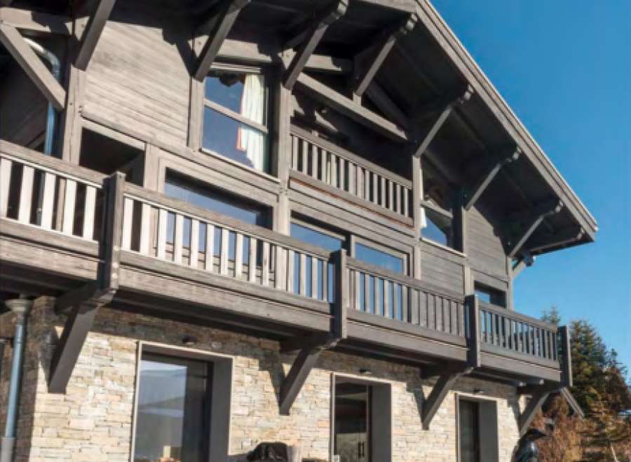 This stunning chalet boasts a unique blend of rustic charm and modern elegance.