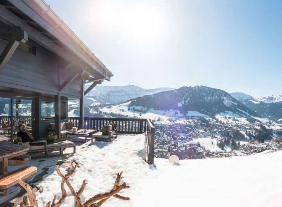 Luxury chalet with breathtaking panoramic views of the snowy mountains and charming village.