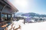 Luxury chalet with breathtaking panoramic views of the snowy mountains and charming village.