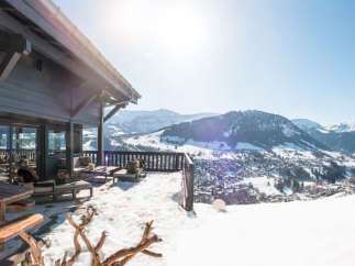 Luxury chalet with breathtaking panoramic views of the snowy mountains and charming village.