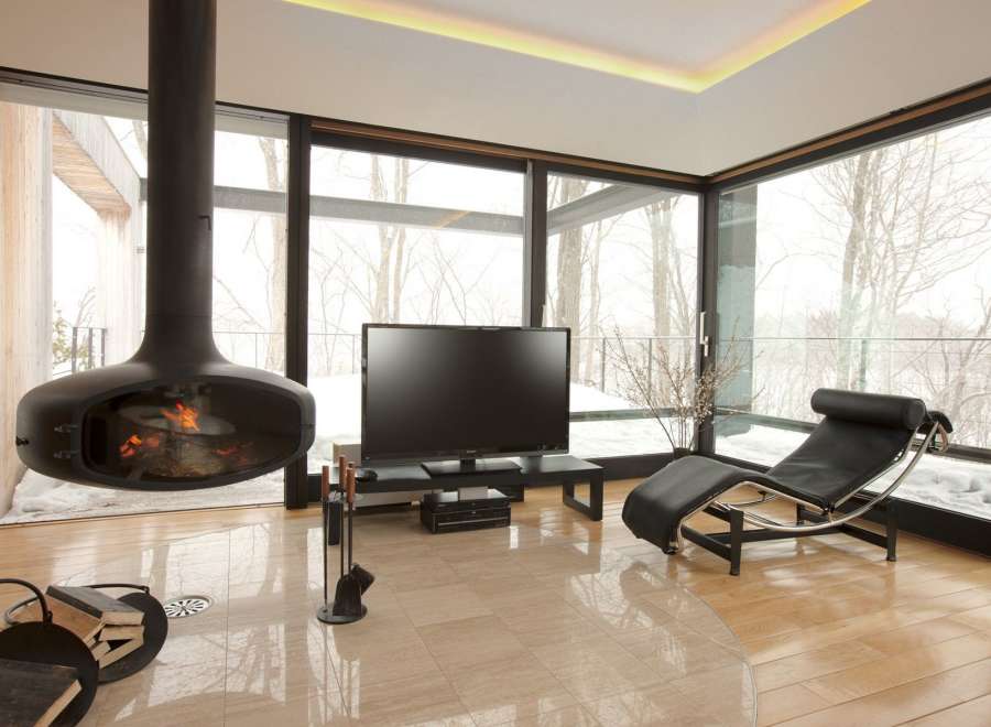 Stunning modern living room with a unique suspended fireplace as a centerpiece.