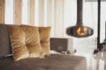 Cozy up by the fireplace in this stunning living room, featuring plush velvet cushions and a modern design.