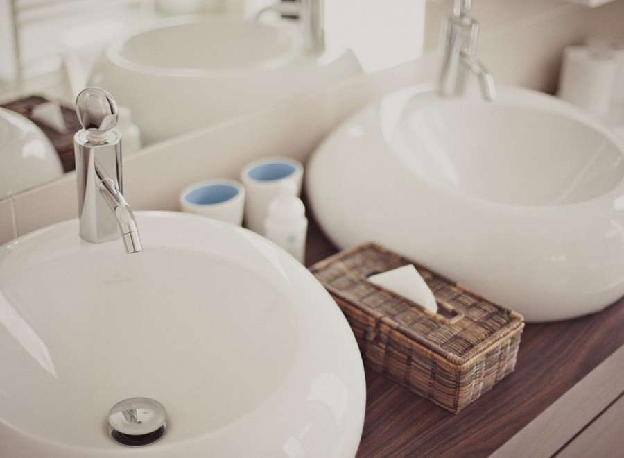 Indulge in our luxurious bathroom featuring sleek, modern sinks and premium fixtures.