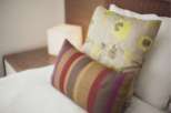 Relax in our comfortable beds, featuring luxurious linens and stylish throw pillows.