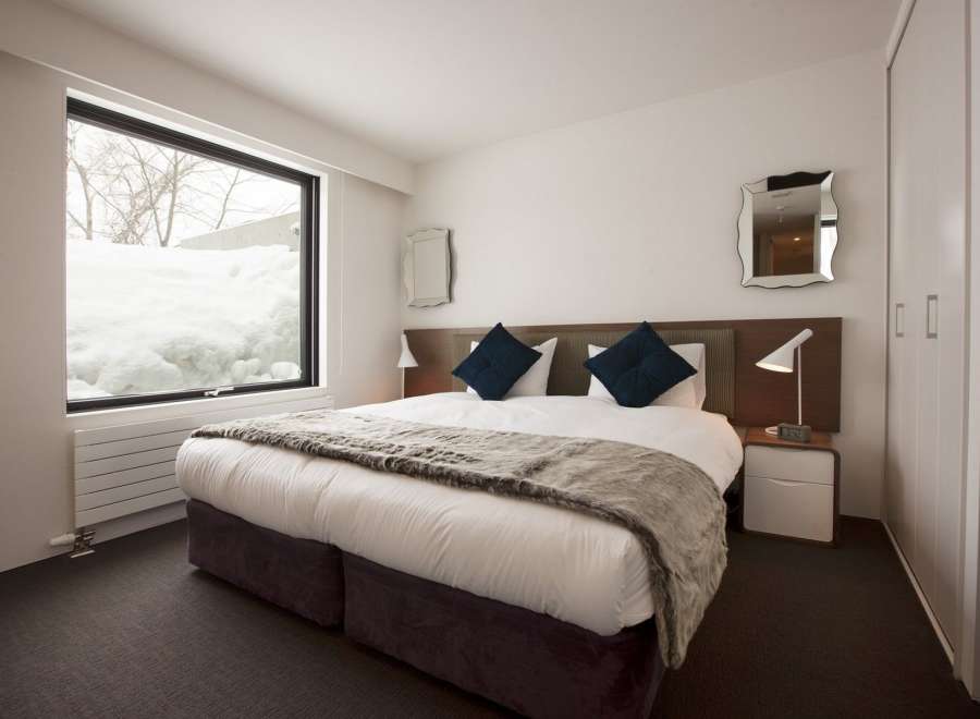 Wake up to stunning views of snow-covered landscapes from this cozy bedroom.