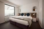 Wake up to stunning views of snow-covered landscapes from this cozy bedroom.