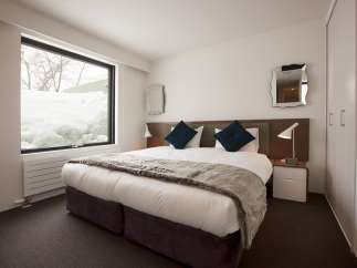 Wake up to stunning views of snow-covered landscapes from this cozy bedroom.