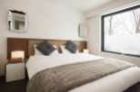 Cozy bedroom with a king-size bed, plush pillows, and a faux fur throw.