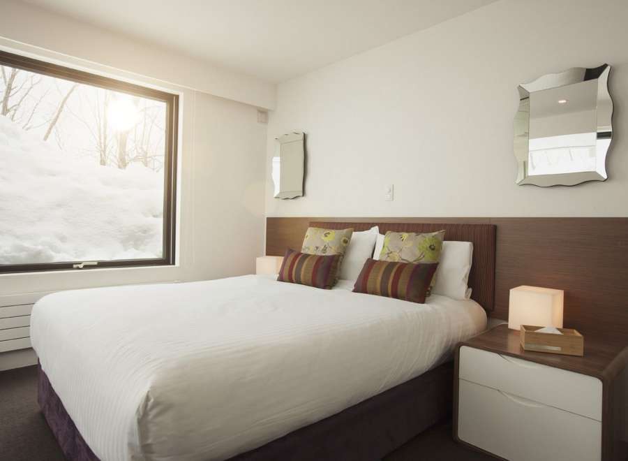 Wake up to breathtaking snowy views from this cozy bedroom.