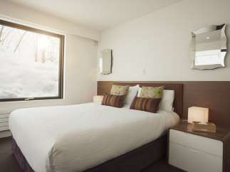 Wake up to breathtaking snowy views from this cozy bedroom.