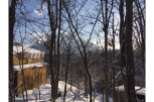 Nestled in a snowy forest, this stunning property offers breathtaking views of majestic mountains.