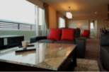 Luxurious apartment boasting stunning city views from floor-to-ceiling windows.