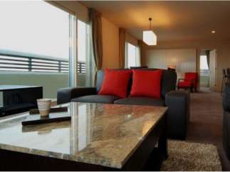 Luxurious apartment boasting stunning city views from floor-to-ceiling windows.