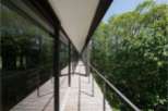 This stunning property boasts a modern design with expansive windows offering breathtaking views of the lush forest.
