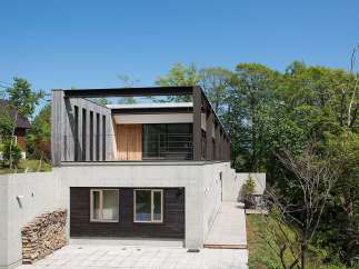 Stunning contemporary home nestled in a lush forest setting.