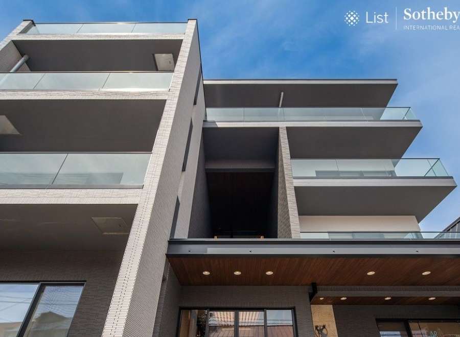 This stunning modern building boasts sleek architecture and multiple balconies, offering residents breathtaking views and ample outdoor space.
