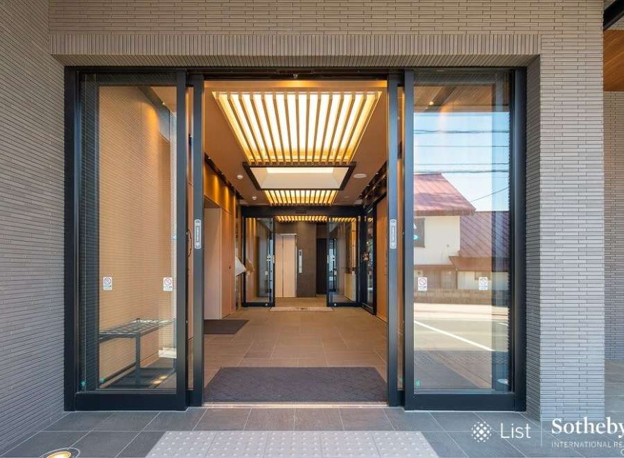 Modern building with sleek glass and metal entrance.