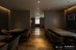 Sophisticated dining area with sleek, dark tables and comfortable seating.