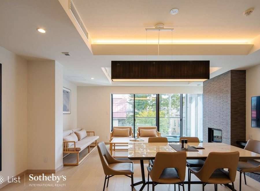 This stunning modern home boasts an open floor plan, seamlessly connecting the living and dining areas.