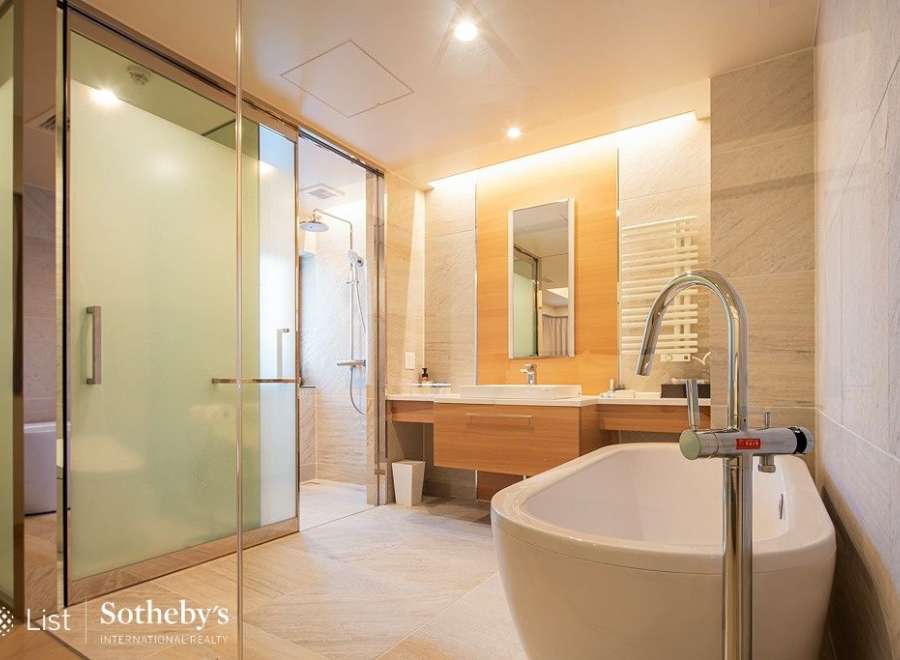 Luxurious bathroom with a freestanding bathtub and a walk-in shower, featuring modern fixtures and elegant design.