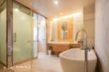 Luxurious bathroom with a freestanding bathtub and a walk-in shower, featuring modern fixtures and elegant design.