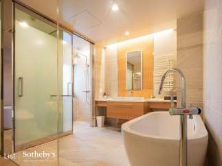 Luxurious bathroom with a freestanding bathtub and a walk-in shower, featuring modern fixtures and elegant design.