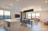 This stunning property boasts an open-concept living space with floor-to-ceiling windows offering breathtaking views.