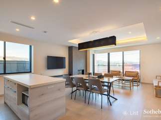 This stunning property boasts an open-concept living space with floor-to-ceiling windows offering breathtaking views.