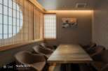 This exquisite dining room boasts a serene ambiance, highlighted by stunning shoji screens and a captivating Great Wave artwork.