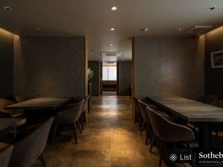 Sophisticated dining area with sleek, dark tables and comfortable seating.