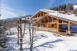 This stunning chalet boasts a prime location in a picturesque snow-covered landscape.