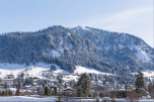 Nestled in a picturesque Swiss village, this stunning property offers breathtaking views of snow-capped mountains and a charming winter landscape.