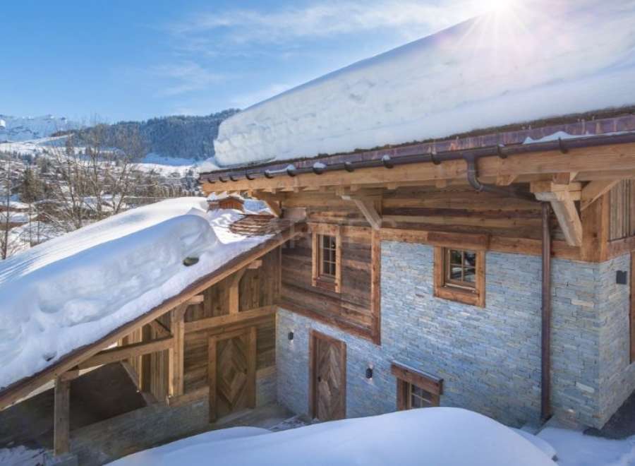 This stunning chalet boasts a unique blend of rustic charm and modern luxury, featuring reclaimed wood and natural stone.