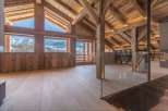 This stunning chalet boasts a spacious open-plan living area with breathtaking mountain views.