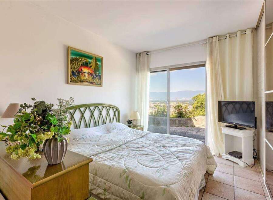 Wake up to breathtaking views from this bedroom with a sliding glass door leading to a private patio.