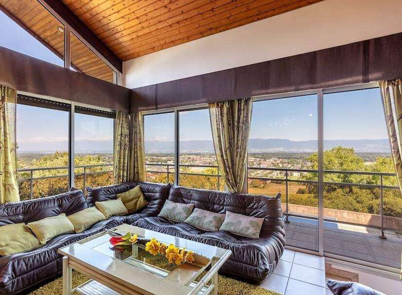Spectacular panoramic views greet you from this stunning home, boasting wall-to-wall windows showcasing breathtaking scenery.