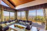 Spectacular panoramic views greet you from this stunning home, boasting wall-to-wall windows showcasing breathtaking scenery.