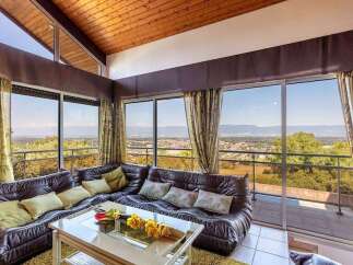Spectacular panoramic views greet you from this stunning home, boasting wall-to-wall windows showcasing breathtaking scenery.