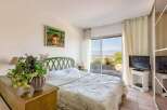 Wake up to breathtaking views from this bedroom with a sliding glass door leading to a private patio.